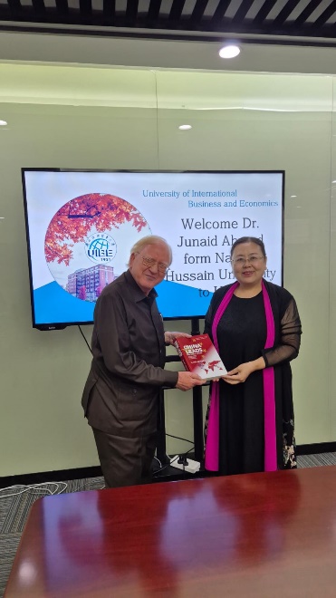 Dr Junaid Ahmad presenting his book on China to Ms Jinlan Liu, Dean at UIBE.